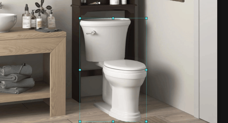 A toilet selected with a cyan box, set against the vanity and the over-toilet cabinet.